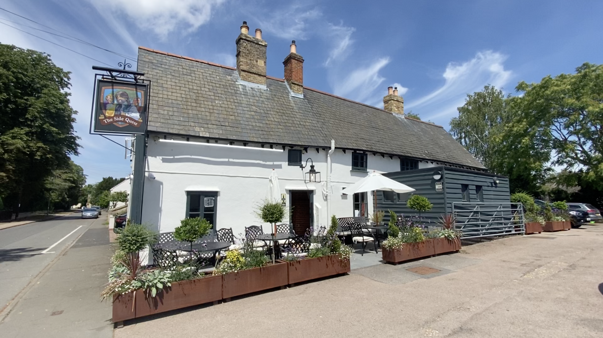 Exterior of The Side Quest pub with outdoor seating in Little Shelford.